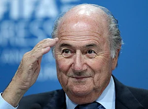 | Photo: AP/Michael Probst : In this June 1, 2011, file photo, Sepp Blatter gestures during a press conference in Zurich, Switzerland.