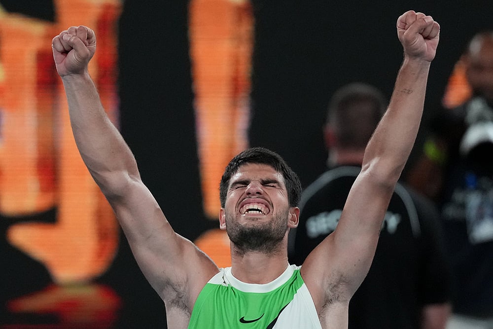 Carlos Alcaraz of Spain celebrates after defeating Alex de Minaur of Australia in their quarterfinal match at the Australian Open tennis championship in Melbourne, Australia. - | Photo: AP/Dita Alangkara