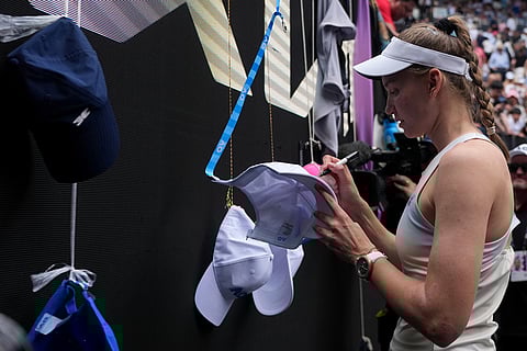 Elena Rybakina of Kazakhstan signs after defeating Iga Swiatek of Poland in their quarterfinal match at the Australian Open tennis championship in Melbourne, Australia.