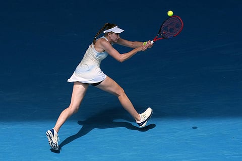 Elena Rybakina of Kazakhstan plays a backhand return to Iga Swiatek of Poland during their quarterfinal match at the Australian Open tennis championship in Melbourne, Australia.