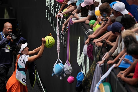 Jessica Pegula of the U.S. signs autographs after defeating compatriot Amanda Anisimova during their quarterfinal match at the Australian Open tennis championship in Melbourne, Australia.