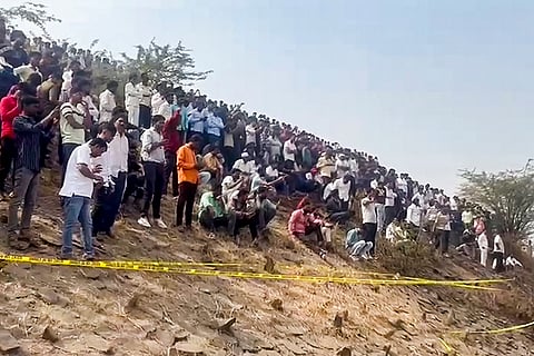 Locals gather near the spot after an aircraft carrying Maharashtra Deputy Chief Minister Ajit Pawar crashed during landing, near Baramati in Pune district, Maharashtra.