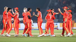 Photo: BCCI via PTI : Gujarat Giants' players celebrate after winning the match against Delhi Capitals during the Women’s Premier League (WPL) 2026 T20 cricket match at the BCA Stadium, in Vadodara, Gujarat.