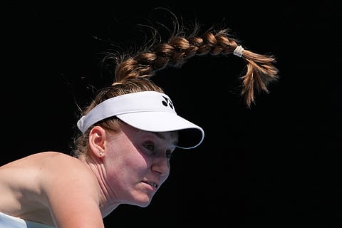 Elena Rybakina of Kazakhstan serves to Iga Swiatek of Poland during their quarterfinal match at the Australian Open tennis championship in Melbourne, Australia.
