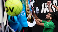 (AP Photo/Dar Yasin) : Novak Djokovic of Serbia signs autographs after his quarterfinal match against Lorenzo Musetti of Italy at the Australian Open tennis championship in Melbourne, Australia, Wednesday, Jan. 28, 2026. 