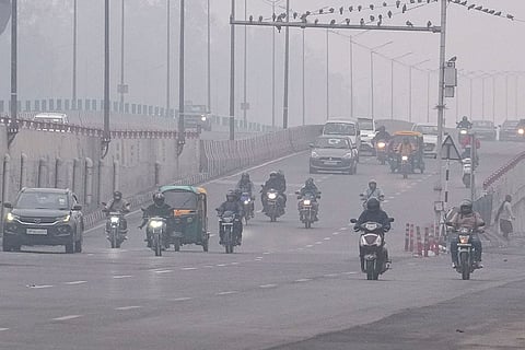 Vehicles move on a foggy winter morning, in New Delhi.