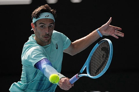 Lorenzo Musetti of Italy plays a backhand return to Novak Djokovic of Serbia during their quarterfinal match at the Australian Open tennis championship in Melbourne, Australia.