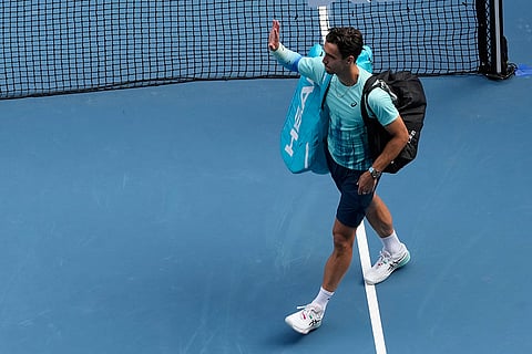 Lorenzo Musetti of Italy waves as he leaves the court after withdrawing from his quarterfinal against Novak Djokovic of Serbia at the Australian Open tennis championship in Melbourne, Australia.