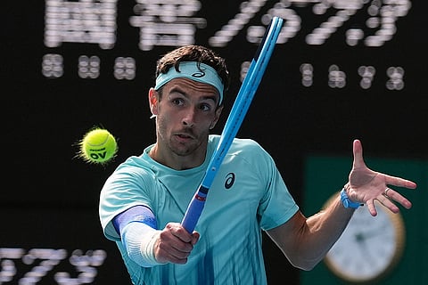Lorenzo Musetti of Italy plays a backhand return to Novak Djokovic of Serbia during their quarterfinal match at the Australian Open tennis championship in Melbourne, Australia.