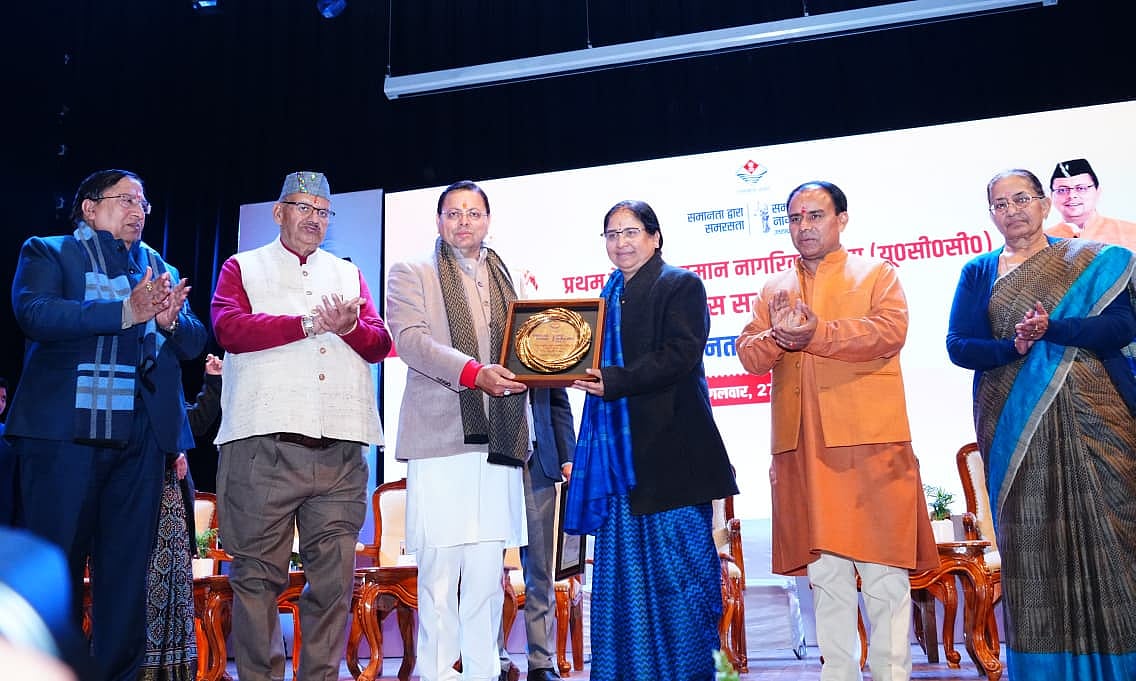 CM Dhami presenting an award