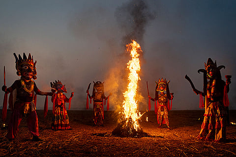 Gamira performers enact a traditional dance around a fire in Khagail village, Kushmundi area of Dakshin Dinajpur district, West Bengal. Gamira, a traditional masked folk dance featuring various mythological characters, is performed without vocal music. The wooden masks of 'Kushmundi', known as Gamira masks or 'Mukha', are a traditional craft from the Dakshin Dinajpur district and were awarded the Geographical Indication (GI) tag in 2018.