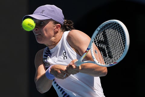 Iga Swiatek of Poland plays a backhand return to Elena Rybakina of Kazakhstan during their quarterfinal match at the Australian Open tennis championship in Melbourne, Australia.