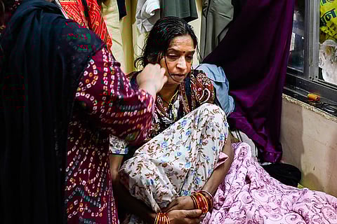 Mother of Pinky Mali, who was a flight attendant on the Learjet 46 that crash-landed in Pune's Baramati, being consoled by a family member at her residence, in Mumbai. Mali, along with Maharashtra Chief Minister Ajit Pawar and three others, was killed in the incident. 