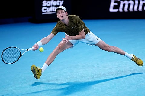 Jannik Sinner of Italy plays a forehand return to Ben Shelton of the U.S. during their quarterfinal match at the Australian Open tennis championship in Melbourne, Australia.