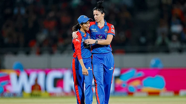 Delhi Capitals' Marizanne Kapp celebrates with captain Jemimah Rodrigues after taking the wicket of Royal Challengers Bengaluru's Georgia Voll during the Women's Premier League (WPL) 2026 T20 cricket match between Royal Challengers Bengaluru and Delhi Capitals, at BCA Stadium, in Vadodara, Gujarat. - | Photo: BCCI via PTI