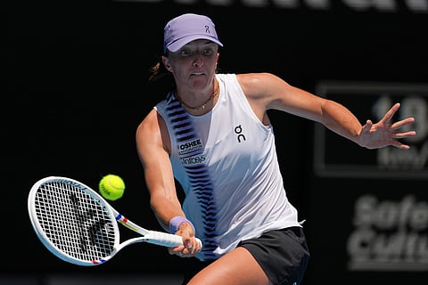 Iga Swiatek of Poland plays a forehand return to Elena Rybakina of Kazakhstan during their quarterfinal match at the Australian Open tennis championship in Melbourne, Australia.