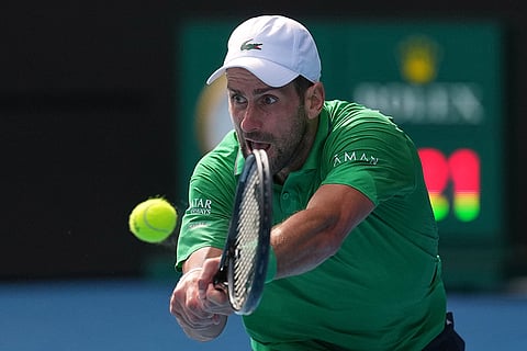 Novak Djokovic of Serbia plays a backhand return to Lorenzo Musetti of Italy during their quarterfinal match at the Australian Open tennis championship in Melbourne, Australia.