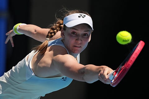 Elena Rybakina of Kazakhstan plays a backhand return to Iga Swiatek of Poland during their quarterfinal match at the Australian Open tennis championship in Melbourne, Australia.