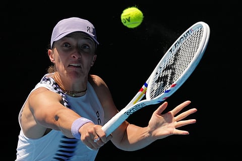 Iga Swiatek of Poland plays a backhand return to Elena Rybakina of Kazakhstan during their quarterfinal match at the Australian Open tennis championship in Melbourne, Australia.