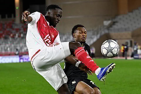 Monaco's Jordan Teze, left, and Juventus' Lois Openda challenge for the ball during the Champions League opening phase soccer match between Monaco and Juventus in Monaco.