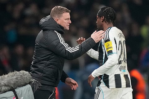 Newcastle's coach Eddie Howe greets Newcastle's Anthony Elanga as he is substituted during a Champions League opening phase soccer match between Paris Saint-Germain and Newcastle in Paris.