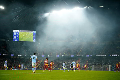 Manchester City's Bernardo Silva runs with the ball as the rain comes down during the Champions League opening phase soccer match Manchester City and Galatasaray in Manchester, England.