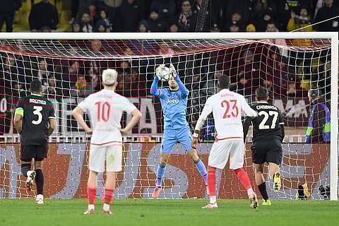 Juventus' goalkeeper Mattia Perin, centre, catches the ball during the Champions League opening phase soccer match between Monaco and Juventus in Monaco.