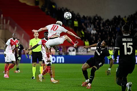 Monaco's Aleksandr Golovin, top, heads the ball during the Champions League opening phase soccer match between Monaco and Juventus in Monaco.