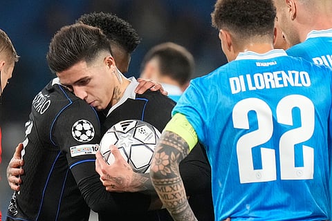 Chelsea's Enzo Fernandez hugs with his teammate Estevao before kicking a penalty kick during a Champions League opening phase soccer match between Napoli and Chelsea, in Naples, Italy.