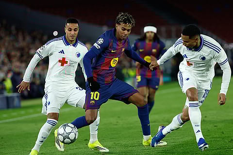 Barcelona's Lamine Yamal fights for the ball against Copenhagen's Marcos Lopez during the Champions League opening phase soccer match between Barcelona and Copenhagen in Barcelona, Spain.