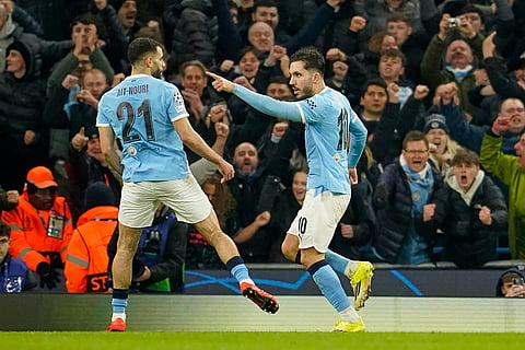 Manchester City's Rayan Cherki, right, celebrates after scoring his side's second goal during the Champions League opening phase soccer match Manchester City and Galatasaray in Manchester, England.