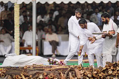 Parth Pawar, centre, and Jay Pawar, left, perform rituals during the funeral of their father and Maharashtra Deputy Chief Minister Ajit Pawar, at the Vidya Pratishthan ground, in Baramati, Pune district.
