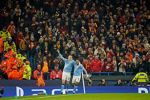 Manchester City's Erling Haaland, left, celebrates with Omar Marmoush after scoring the opening goal during the Champions League opening phase soccer match Manchester City and Galatasaray in Manchester, England.