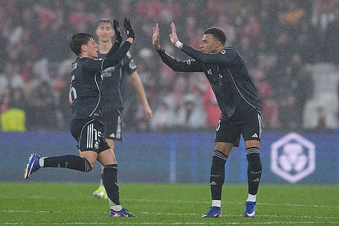 Real Madrid's Kylian Mbappe, right, celebrates with teammate Gonzalo Garcia after scoring his side's second goal during a Champions League opening phase soccer match between Benfica and Real Madrid, in Lisbon.