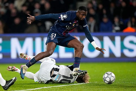 PSG's Willian Pacho jumps over Newcastle's Anthony Gordon during a Champions League opening phase soccer match between Paris Saint-Germain and Newcastle in Paris.