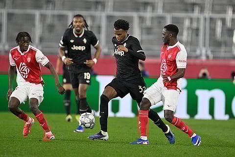 Juventus' Juan Cabal, second from right, and Monaco's Jordan Teze, right, challenge for the ball during the Champions League opening phase soccer match between Monaco and Juventus in Monaco.