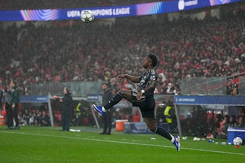 Real Madrid's Vinicius Junior jumps to play the ball during a Champions League opening phase soccer match between Benfica and Real Madrid, in Lisbon.