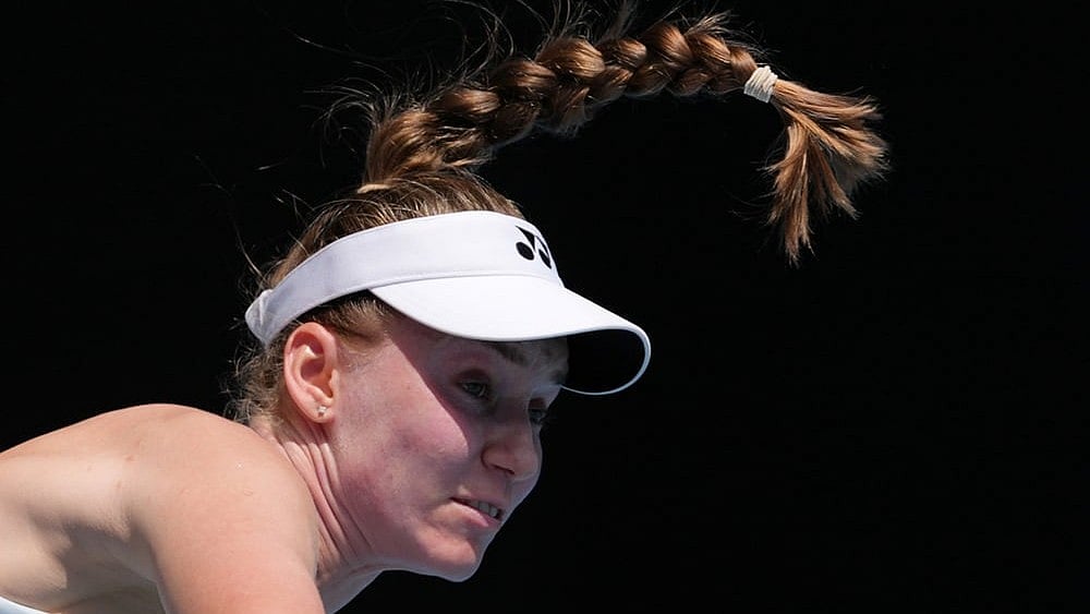 Elena Rybakina of Kazakhstan serves to Iga Swiatek of Poland during their quarterfinal match at the Australian Open tennis championship in Melbourne, Australia. - | Photo: AP/Aaron Favila