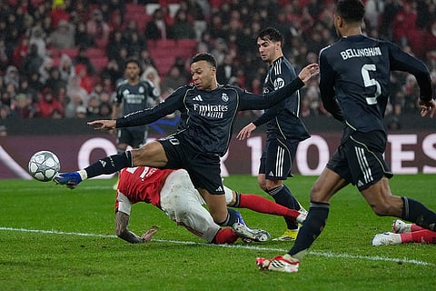 Real Madrid's Kylian Mbappe attempts a shoot at goal during a Champions League opening phase soccer match between Benfica and Real Madrid, in Lisbon.