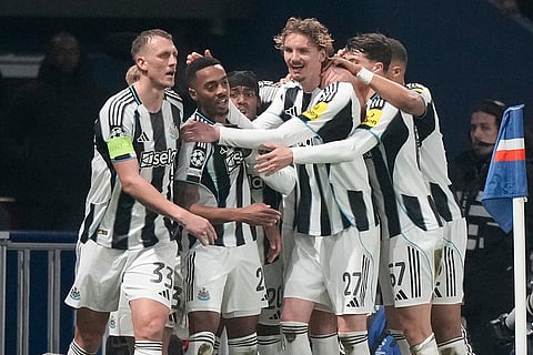 Newcastle's Joe Willock, center left, celebrates after scoring his side's opening goal during a Champions League opening phase soccer match between Paris Saint-Germain and Newcastle in Paris.