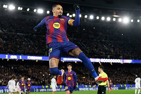 Barcelona's Raphinha celebrates his side's third goal from a penalty kick during the Champions League opening phase soccer match between Barcelona and Copenhagen in Barcelona, Spain.