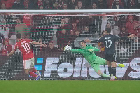 Real Madrid's goalkeeper Thibaut Courtois makes a save during a Champions League opening phase soccer match between Benfica and Real Madrid, in Lisbon.