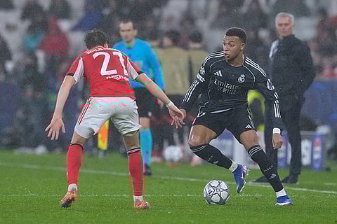 Real Madrid's Kylian Mbappe, right, vies for the ball with Benfica's Andreas Schjelderup during a Champions League opening phase soccer match between Benfica and Real Madrid, in Lisbon.