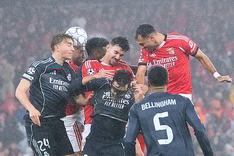 Benfica's Tomas Araujo, center, goes for a header against Real Madrid's Dean Huijsen, left, during a Champions League opening phase soccer match between Benfica and Real Madrid, in Lisbon.
