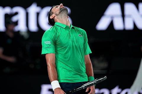 Novak Djokovic of Serbia reacts during his semifinal match against Jannik Sinner of Italy at the Australian Open tennis championship in Melbourne, Australia.