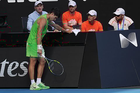 Carlos Alcaraz of Spain talks to his team during his semifinal match against o Alexander Zverev of Germany at the Australian Open tennis championship in Melbourne, Australia.