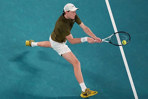 Jannik Sinner of Italy plays a backhand return to Novak Djokovic of Serbia during their semifinal match at the Australian Open tennis championship in Melbourne, Australia.