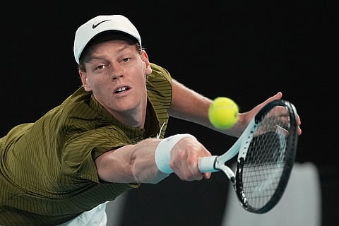 Jannik Sinner of Italy plays a backhand return to Novak Djokovic of Serbia during their semifinal match at the Australian Open tennis championship in Melbourne, Australia.