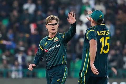 Australia's Adam Zampa, left, celebrates with teammate after the dismissal of Pakistan's Usman Khan during the first T20 cricket match between Pakistan and Australia, in Lahore, Pakistan.