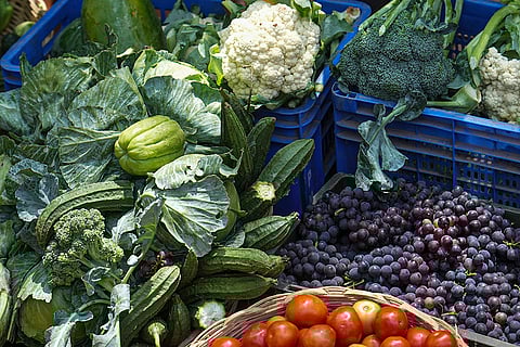 Various crates of fruits and vegetables are displayed at a market, in Bengaluru, Karnataka.